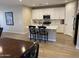 Bright kitchen featuring white cabinets, stainless steel appliances, and a functional island with barstool seating at 25657 N 185Th Dr, Surprise, AZ 85387