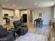 Open-concept living space with tile flooring, a modern kitchen, a dining area, and comfortable seating at 25657 N 185Th Dr, Surprise, AZ 85387
