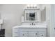 Bright white bathroom vanity with sleek faucet, mirror, and white tile flooring at 2615 N Hayden Rd # 114, Scottsdale, AZ 85257