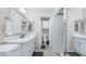 Clean bathroom with a white vanity, mirror, and view into the toilet and shower space at 2615 N Hayden Rd # 114, Scottsdale, AZ 85257