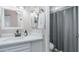 Bathroom featuring vanity with modern fixtures, mirror and shower with gray shower curtain at 2615 N Hayden Rd # 114, Scottsdale, AZ 85257