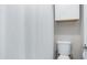 Clean, bright bathroom featuring a shower with white curtain, and a toilet at 2615 N Hayden Rd # 114, Scottsdale, AZ 85257