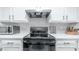 Stove, microwave, knife block and other kitchen essentials on quartz countertop at 2615 N Hayden Rd # 114, Scottsdale, AZ 85257
