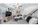 Spacious living room with comfortable sectional sofa, ceiling fan, and staircase at 2615 N Hayden Rd # 114, Scottsdale, AZ 85257