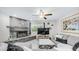 Comfortable living room features a stone fireplace, ceiling fan, and modern decor at 2615 N Hayden Rd # 114, Scottsdale, AZ 85257