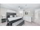 Spacious main bedroom features a king bed, and view into the ensuite bathroom with long white dresser at 2615 N Hayden Rd # 114, Scottsdale, AZ 85257