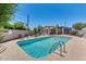 Inviting pool area with lounge chairs, shaded seating, and clear blue water for relaxation at 2615 N Hayden Rd # 114, Scottsdale, AZ 85257
