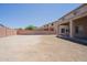 Expansive backyard with block wall, covered patio, and desert landscaping provides ample space for outdoor living at 30268 W Sheila Ln, Buckeye, AZ 85396