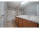 Well-lit bathroom with double sinks, and a shower-tub combo at 30268 W Sheila Ln, Buckeye, AZ 85396