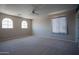 Spacious bedroom with windows allowing natural light, ceiling fan and neutral carpet at 30268 W Sheila Ln, Buckeye, AZ 85396