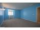 A bright bedroom features a carpeted floor, and a bright window at 30268 W Sheila Ln, Buckeye, AZ 85396