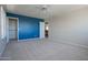 Comfortable bedroom with blue accent wall, walk-in closet, and neutral-colored carpet flooring at 30268 W Sheila Ln, Buckeye, AZ 85396