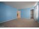 A bright and relaxing bedroom features a carpeted floor, and access to other rooms at 30268 W Sheila Ln, Buckeye, AZ 85396