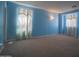 A relaxing bedroom features a carpeted floor, and two bright windows at 30268 W Sheila Ln, Buckeye, AZ 85396