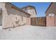 Exterior angle shows stucco house with gated area and white gravel at 30268 W Sheila Ln, Buckeye, AZ 85396