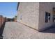 Exterior view shows side yard with gravel landscaping and privacy fence at 30268 W Sheila Ln, Buckeye, AZ 85396