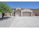 Lovely two-story home featuring an attached three-car garage and desert landscaping at 30268 W Sheila Ln, Buckeye, AZ 85396