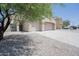 Inviting home with a three-car garage, long driveway, and low-maintenance desert landscaping at 30268 W Sheila Ln, Buckeye, AZ 85396