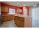 Well-lit kitchen with tile floors, wooden cabinets, and a functional center island at 30268 W Sheila Ln, Buckeye, AZ 85396
