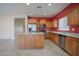 Contemporary kitchen with tile flooring, stainless steel appliances, and ample counter space at 30268 W Sheila Ln, Buckeye, AZ 85396