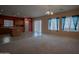 Open-concept living space connected to kitchen with eat-in island and backyard access at 30268 W Sheila Ln, Buckeye, AZ 85396