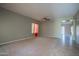Spacious living room with neutral carpet, tile flooring, ceiling fan, and natural light at 30268 W Sheila Ln, Buckeye, AZ 85396