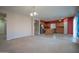 Spacious living room open to a kitchen with stainless appliances and a center island at 30268 W Sheila Ln, Buckeye, AZ 85396