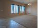 Bright living room featuring plush carpeting and stylish window treatments at 30268 W Sheila Ln, Buckeye, AZ 85396