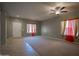 Expansive living room featuring tile and carpet floors, neutral walls, and bright windows at 30268 W Sheila Ln, Buckeye, AZ 85396