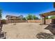Dirt backyard with covered patio and block fence under a bright blue sky at 3228 W Saint Anne Ave, Phoenix, AZ 85041