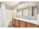 Bathroom with double sinks, granite countertop, tub, and shower at 3228 W Saint Anne Ave, Phoenix, AZ 85041