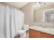 Neutral bathroom featuring granite countertop vanity, toilet, and white shower curtain at 3228 W Saint Anne Ave, Phoenix, AZ 85041