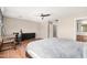 Spacious bedroom with a ceiling fan, desk, dresser, and ensuite bathroom at 3228 W Saint Anne Ave, Phoenix, AZ 85041