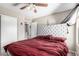 Neutral bedroom features a ceiling fan, gray tufted headboard and a closet at 3228 W Saint Anne Ave, Phoenix, AZ 85041