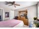 Neutral bedroom features a ceiling fan and wooden dresser with mirror and drawers at 3228 W Saint Anne Ave, Phoenix, AZ 85041