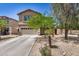 Inviting two-story home with a well-maintained front yard, featuring desert landscaping and a two-car garage at 3228 W Saint Anne Ave, Phoenix, AZ 85041