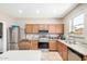 Kitchen featuring stainless appliances, light wood cabinets and granite countertops at 3228 W Saint Anne Ave, Phoenix, AZ 85041