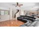 Spacious living room with wood laminate floors and an open layout flowing into the kitchen at 3228 W Saint Anne Ave, Phoenix, AZ 85041