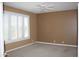 A empty bedroom with neutral colors and shutters on the windows at 34464 N 68Th Way, Scottsdale, AZ 85266
