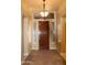 Inviting entryway featuring a decorative wooden door, sidelight windows, and tiled flooring at 34464 N 68Th Way, Scottsdale, AZ 85266