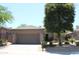 Charming single-story home with a tile roof, desert landscaping, and an attached two-car garage at 34464 N 68Th Way, Scottsdale, AZ 85266