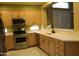 Bright kitchen features stainless steel appliances, light wood cabinetry and tile floor at 34464 N 68Th Way, Scottsdale, AZ 85266