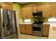 Spacious kitchen featuring stainless steel appliances, tiled flooring, and wood cabinetry at 34464 N 68Th Way, Scottsdale, AZ 85266