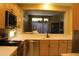 Bright kitchen with modern appliances, wood cabinets, and a view into an adjoining space at 34464 N 68Th Way, Scottsdale, AZ 85266