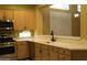 Well-lit kitchen featuring wood cabinetry, stainless steel appliances, and bright countertops at 34464 N 68Th Way, Scottsdale, AZ 85266