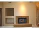 Inviting living room with a fireplace and shelving on the wall at 34464 N 68Th Way, Scottsdale, AZ 85266
