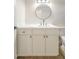 Bathroom featuring a contemporary vanity with a round mirror and minimalist hardware at 3701 W Villa Maria Dr, Glendale, AZ 85308
