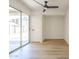 Bright, neutral room with wood-look floors, sliding glass door leading to the outdoors, and a ceiling fan at 3701 W Villa Maria Dr, Glendale, AZ 85308