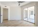 Bright, neutral room with wood-look floors, sliding glass door leading to the outdoors, and a ceiling fan at 3701 W Villa Maria Dr, Glendale, AZ 85308