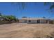 Spacious lot with a view of the back exterior, back patio, and perimeter fencing at 3701 W Villa Maria Dr, Glendale, AZ 85308